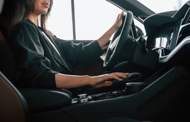 Enjoying the ride. Beautiful businesswoman is in the new car