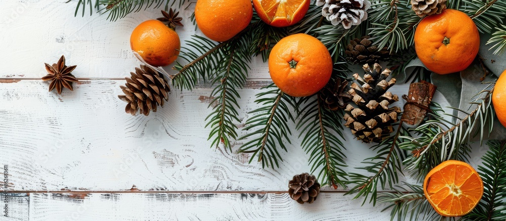 Poster top view of a festive christmas arrangement with fir branches, tangerines, and cones displayed on a 