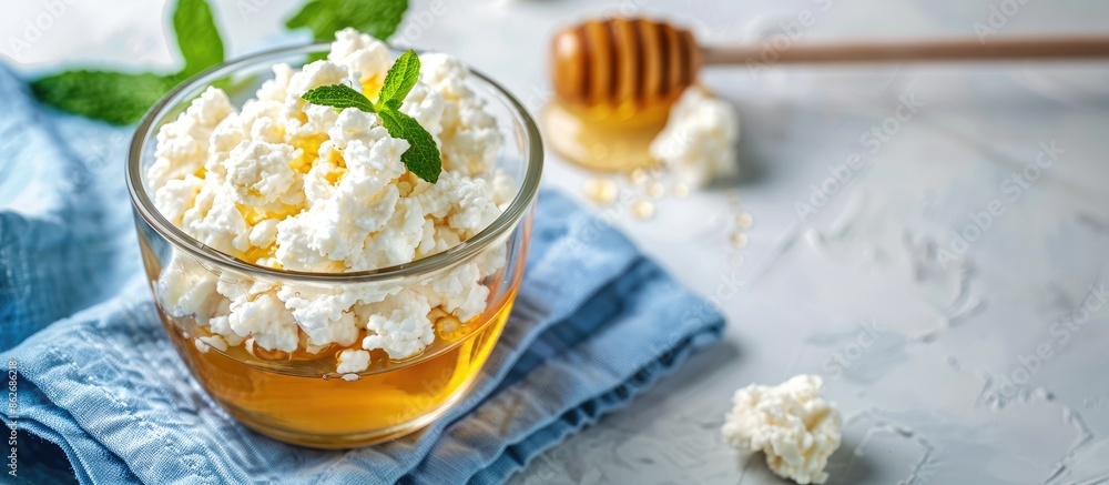 Poster glassware with soft cottage cheese and honey on a blue napkin, a delightful dairy product perfect fo