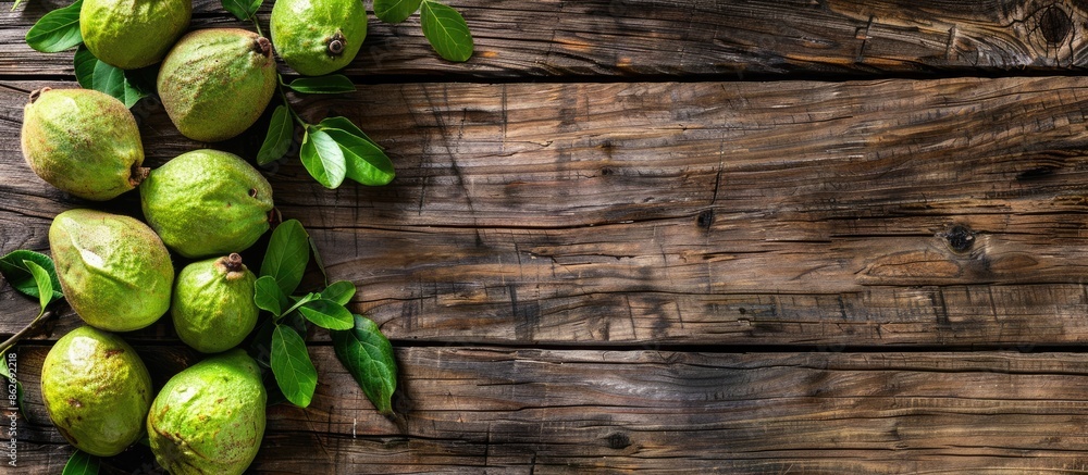 Aufkleber top view of ripe green guavas displayed on a rustic wooden surface with copy space image.