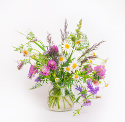Wildflowers bouquet in a jar on white background.
