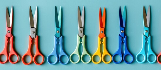 Scissors of different colors placed on a backdrop with copy space image available.