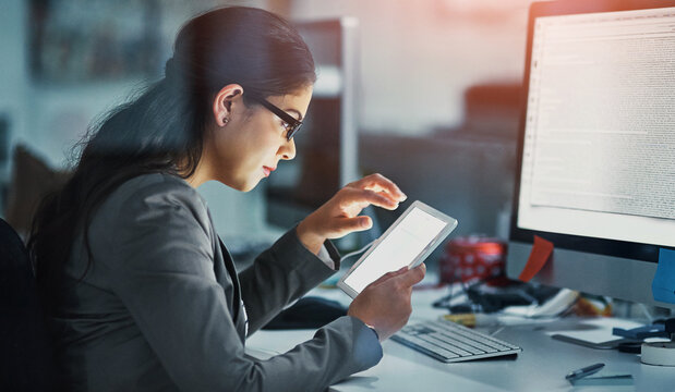 Night, technology and web development with woman at desk in office for coding or programming. Data, information and software with business person in workplace for administration or project management