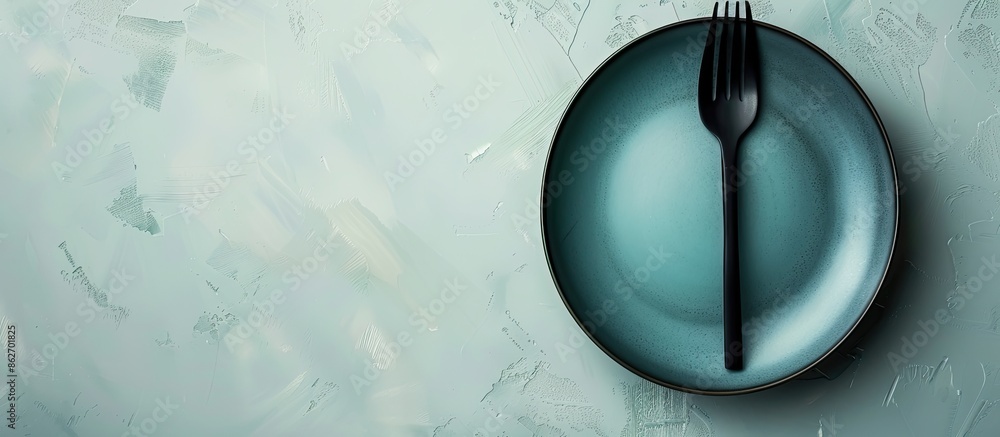 Fototapete Top-down view of ceramic tableware including a plate with a fork on a plain background with space for text or other images. Copy space image. Place for adding text and design