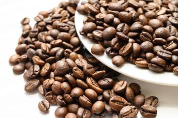 Fototapeta premium Roasted coffee beans on dark background. Selective focus.
