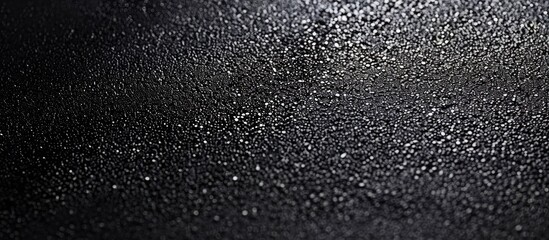 Obraz premium Background with a textured black sandpaper surface for a copy space image.