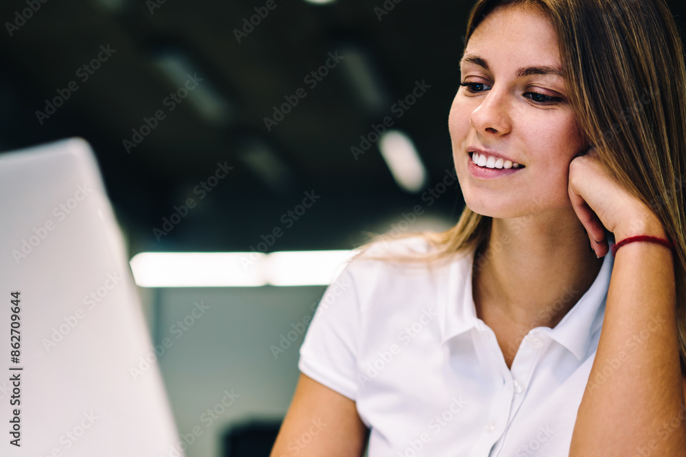 Poster smiling young woman watching video on laptop computer connected on wifi, positive female student enj