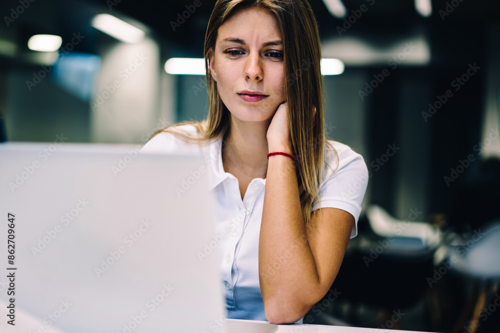 Poster pensive female student watching tutorial concentrated on analyzing information for e-learning on cou