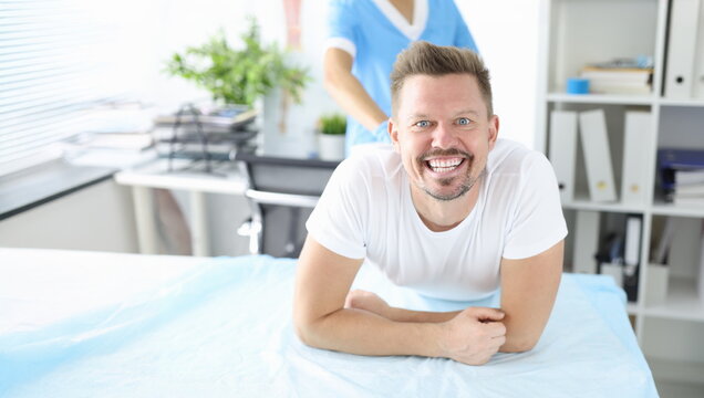 Portrait of smiling man at proctologist appointment. Bowel disease diagnosis concept