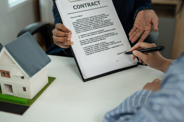 Considering buying a home, investing in real estate. Broker signs a sales agreement. agent, lease agreement, successful deal.