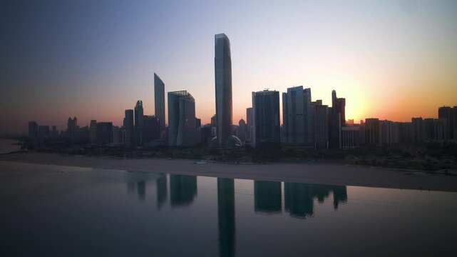 Aerial view of Abu Dhabi skyline at sunset, Dubai, United Arab Emirates.
