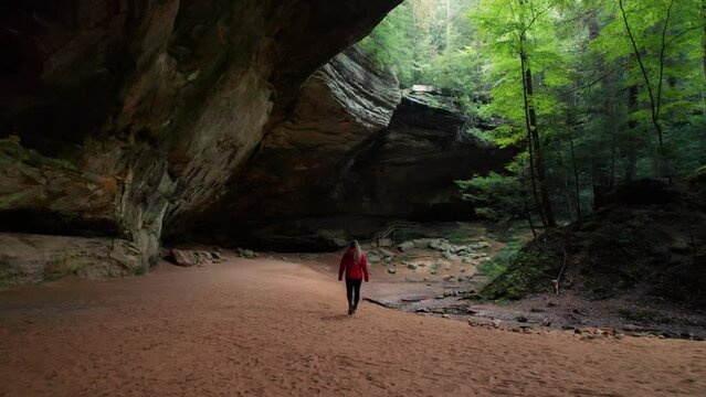 Drone Behind and Over Girl Walking Through Hocking Hills Ash Cave Aerial Forest Trail Scenic View.