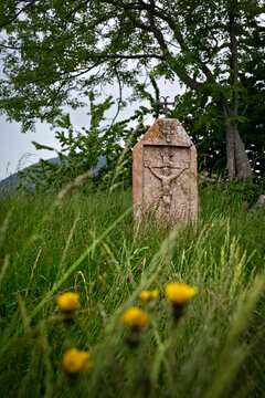 Velo Veronese: ancient folk sculpture of the crucifixion of Jesus Christ in the meadow of Contrada Riva. Azzarino, Lessinia, Veneto, Italy.