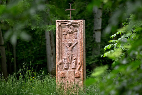 Ancient folk sculpture of the crucifixion of Jesus Christ in the middle of the wood. Contrada Covel, Velo Veronese, Lessinia, Veneto, Italy.