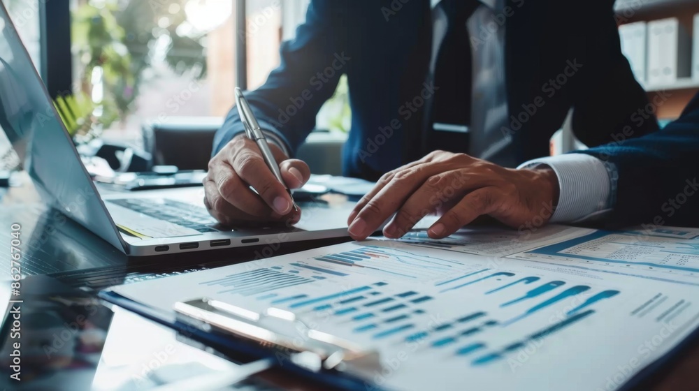 Poster A financial advisor consulting with a client, pointing at a document with investment options and financial charts.