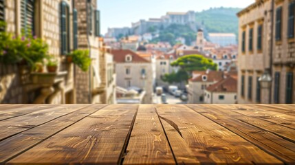 Fototapeta premium Wooden table top with blurred European old town view in background. 