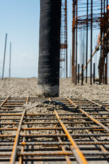 Iron grate or reinforcement on the ground poured with concrete at a construction site