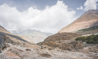Rocky red, russet, orange and brown mountains and cliffs in the Pamirs in the mountains of Tajikistan