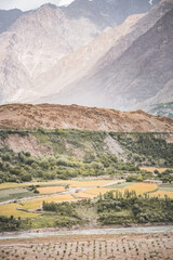 Fields and plantations in the mountains on a sunny day in the mountains of Tajikistan in the Pamirs