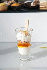 Small glass with parfait as dessert. Detail of a snifter with a cream desert inside. 
