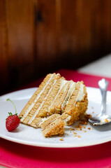 Slice Crepe cake Medovik with sour cream vanilla cream and strawberries. Slice Pancake cake Medovik decorated with strawberries.