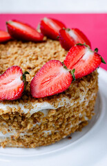 Crepe cake Medovik with sour cream vanilla cream and strawberries. Pancake cake Medovik decorated with strawberries.