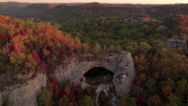 Epic Breathtaking Sunset Natural Bridge Cave Stairs. Drone Around Dramatic Rock Formation to Sunset Sun Flare. Kentucky Forest Tourist Destination