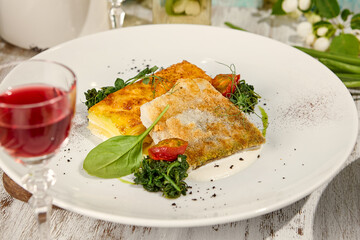 Crispy Fried Pike-Perch with Potato Gratin on Sunlit Wooden Table