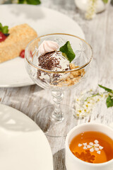 Vanilla Ice Cream in Glass Dish with Sunlight and Wood Background
