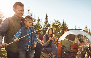 Family, camping and smores in nature or forest for bonding with love, happiness and relax in outdoor with affection. Mother, father and son together for adventure in wilderness, peace and summer trip