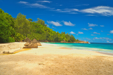 Fototapeta premium Anse Intendance beach, blue sky turquoise water, low tide with waves, sunny day, white sandy beach, Mahe, Seychelles