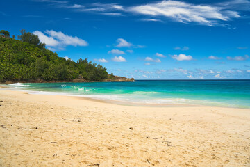 Anse Intendance beach, blue sky turquoise water, low tide with waves, sunny day, white sandy beach, Mahe, Seychelles