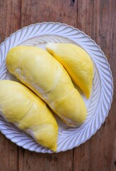 Fresh Durian on white plate , wooden background,  , top view food table, fruit