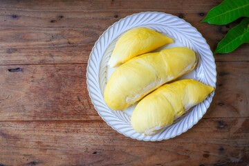 Fresh Durian on white plate , wooden background, , top view food table, fruit