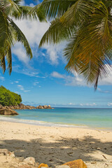 Anse Takamaka, sunny day with blue sky and white sandy beach, turquoise water, Mahe Seychelles