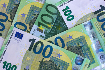 Close-up fragment of one hundred euro banknote with green and yellow details