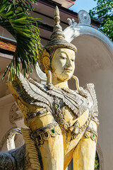 Traditional stone Thai sculpture decorated with gold and gems located in the ancient Wat Pha Lat temple in Chiang Mai, Thailand, a popular tourist spot.