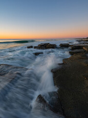Wave crashing into the rock on the coastline.