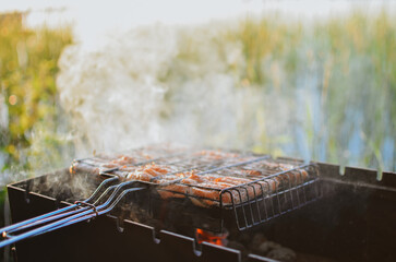 grill with hot coals for cooking grilled meat on the lake on a summer day