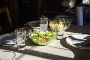 green salad served on white table, table ready for lunch vertical view horizontal view