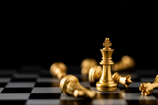 Gold king chess piece stand in front of pawn on black background.