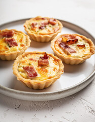 Savory mini quiches. Tasty finger food. Delicious meal. Cooking and culinary concept.