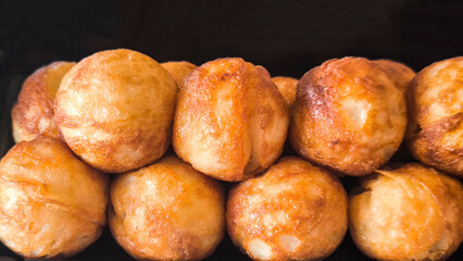 Takoyaki snacks on a black tray, Japanese style food