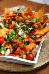 Nacho chips with green onions and spices.