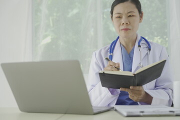 Pharmacist holds a prescription and tries to explain how to use the medicine to a patient. Pharmacy. Asian female health worker is explaining a prescription to a patient. Medicine Pharmacist.