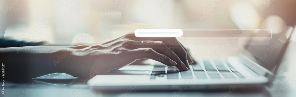 Poster closeup of a hand typing on a laptop keyboard with a search bar overlay, showing modern technology a