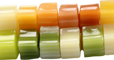 Colorful and glossy stacked cylindrical shapes creating a vibrant pattern of green, yellow, orange, and white hues.