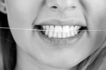 Healthy teeth concept. Oral hygiene and health care. Smiling women use dental floss white healthy...