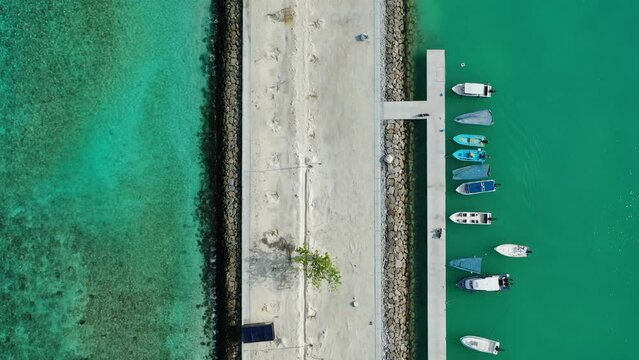 Aerial view of turquoise sea with boats in harbour, Thoddoo, Maldives.