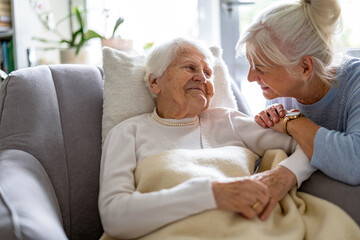 Elderly woman with her caregiver at nursing home
